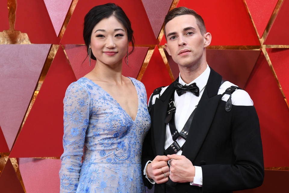 Adam Rippon rocked his bondage harness with Mirai Nagasu on the Academy Awards' red carpet. (Photo: ANGELA WEISS via Getty Images)