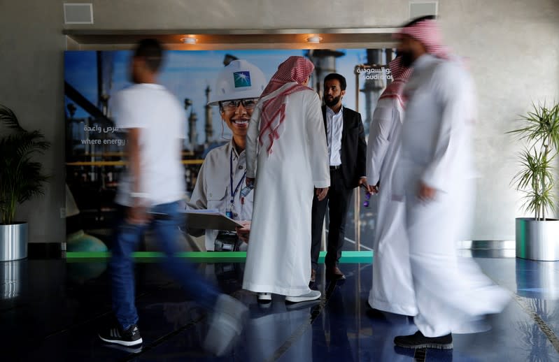 People are seen before the start of a press conference by Aramco at the Plaza Conference Center in Dhahran