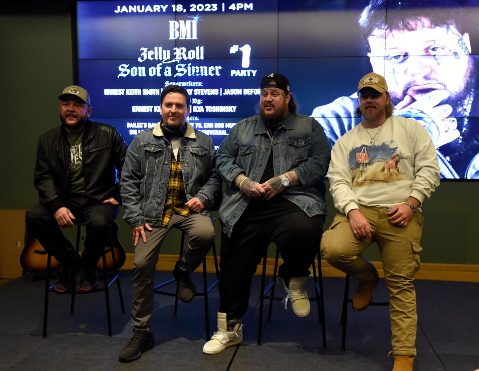 Singer Jelly Roll sits with songwriter David Ray Stevens, left, producer Ilya Toshinsky, and songwriter Ernest Keith Smith, right,  before being honored during a ceremony for their No. 1 song “Son of a Sinner” at BMI on Wednesday, Jan. 18, 2023, in Nashville, Tenn.  