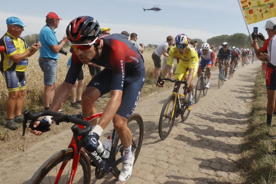 Wout van Aert, in yellow, on the cobbles of northern France (EPA)