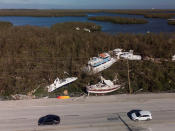 Damaged boats sit on a side of the road after Hurricane Ian caused widespread destruction in Fort Myers Beach, Florida, U.S., September 29, 2022. REUTERS/Marco Bello