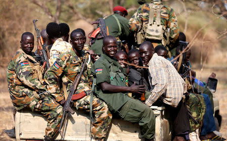 FILE PHOTO - South Sudan's rebels with weapons travel in a truck in a rebel-controlled territory in Jonglei State January 31, 2014. REUTERS/Goran Tomasevic/File Photo