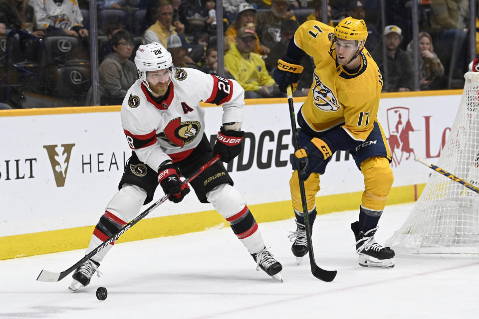 Ottawa Senators right wing Claude Giroux (28) moves the puck ahead of Nashville Predators center Mark Jankowski (17) during the first period of an NHL hockey game Saturday, Dec. 10, 2022, in Nashville, Tenn. (AP Photo/Mark Zaleski)