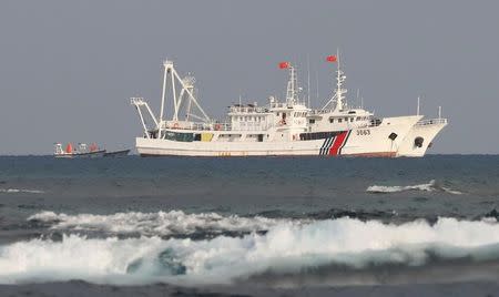 China Coast Guard vessels are pictured at the disputed Scarborough Shoal, April 5, 2017. Picture taken April 5, 2017. REUTERS/Erik De Castro