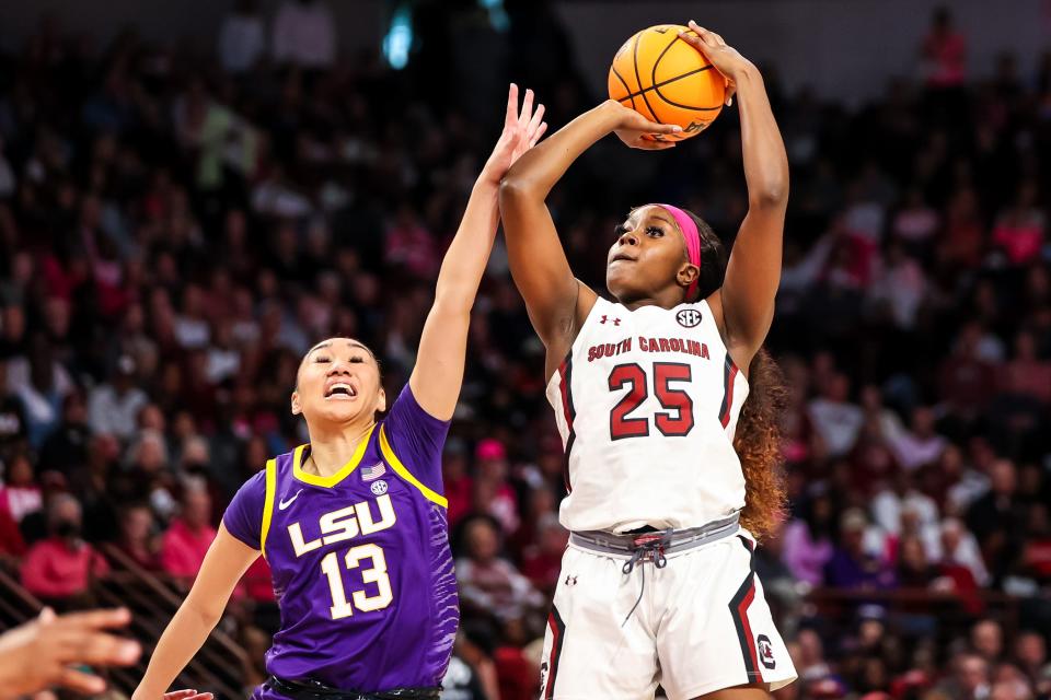 Feb 12, 2023; Columbia, South Carolina, USA; LSU Lady Tigers guard Last-Tear Poa (13) fouls South Carolina Gamecocks guard Raven Johnson (25) in the first half at Colonial Life Arena. Mandatory Credit: Jeff Blake-USA TODAY Sports