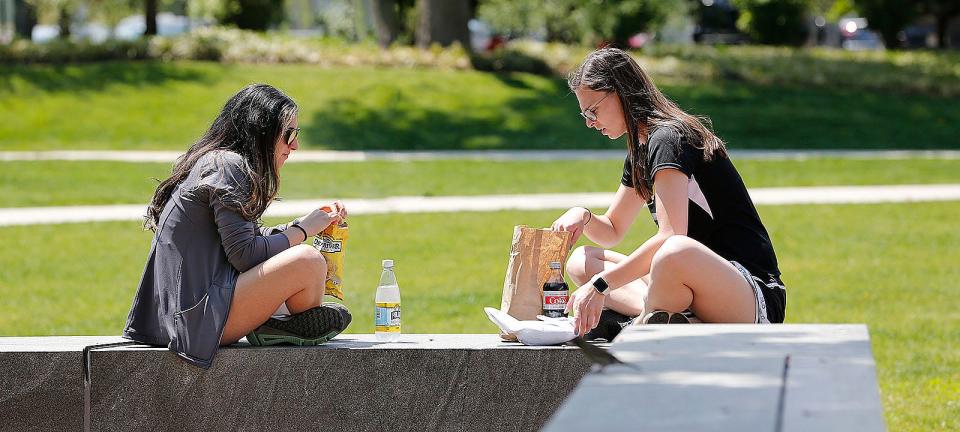 Friends Brianna Johnson and Jackie Polito, of Quincy, enjoy lunch without masks on Monday, May 17, 2021.