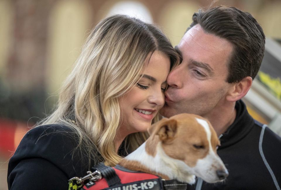 Simon Pagenaud gives a kiss to his wife Hailey Pagenaud, at the unveiling of this year's Indianapolis 500 ticket during a ceremony at City Market, Indianapolis, Tuesday, Jan. 28, 2020.