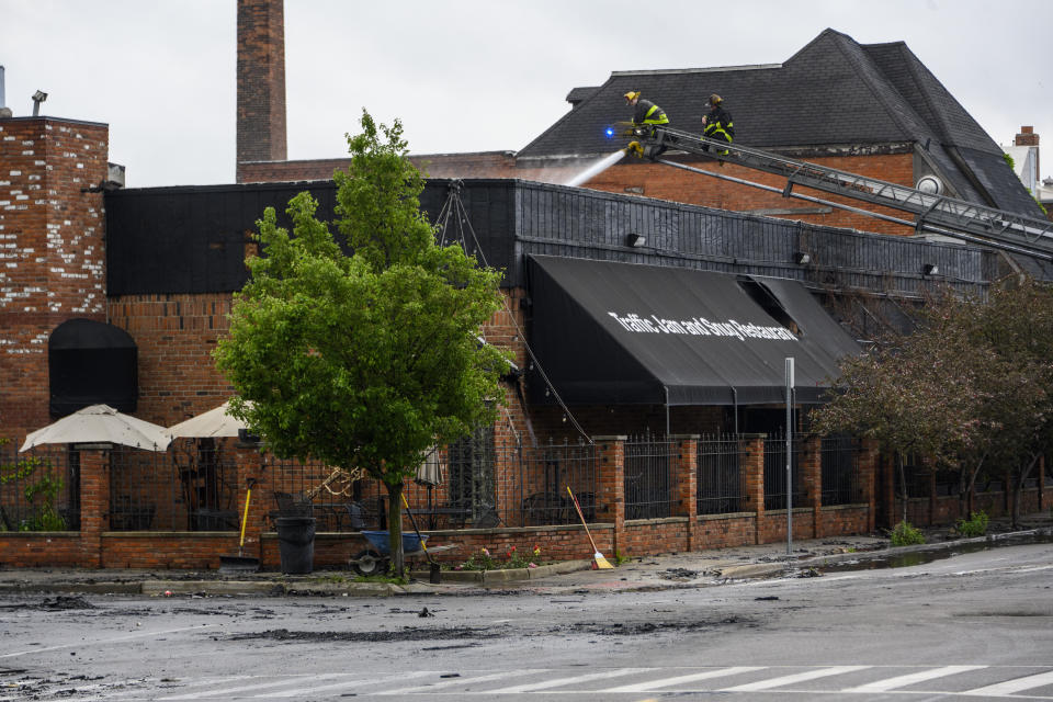 Detroit Fire Department firefighters continue to pour water after an overnight fire at Traffic Jam and Snug Restaurant, Friday, May 27, 2022. (Andy Morrison/Detroit News via AP)