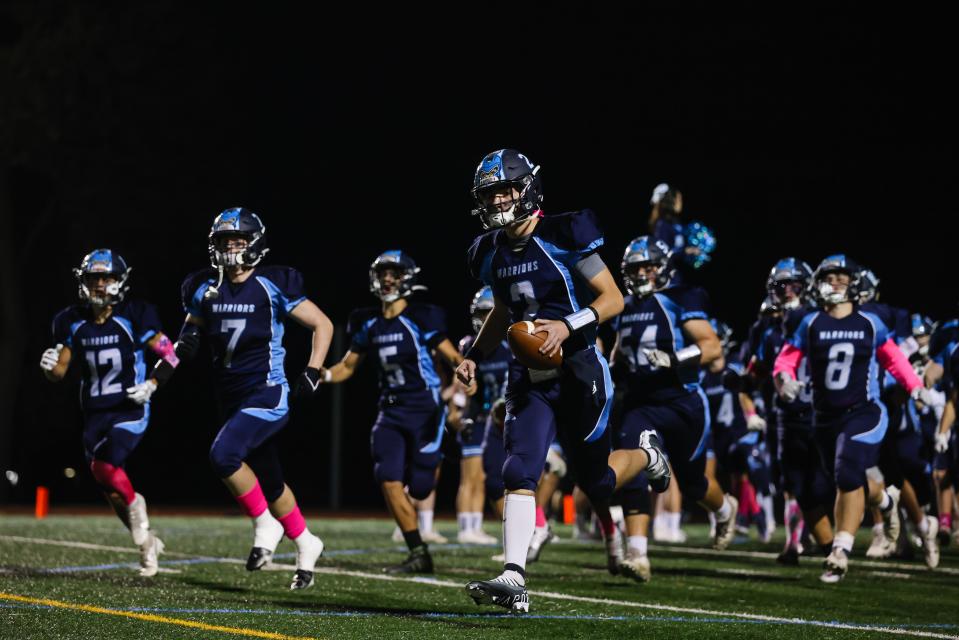 The Waldwick football team runs onto the field prior to their matchup against Wood-Ridge.