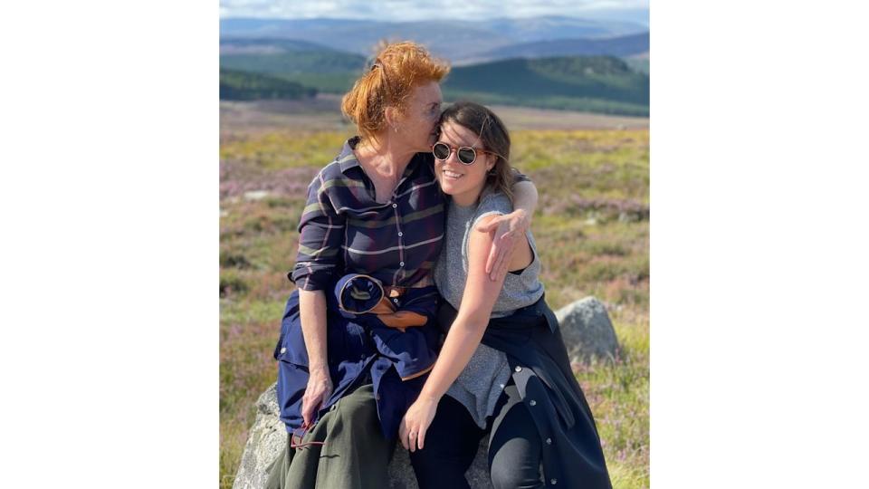 Sarah Ferguson with her arms around Princess Eugenie in the countryside