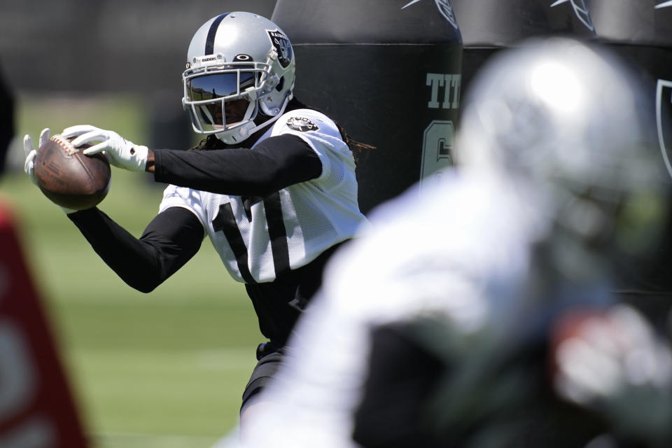 Las Vegas Raiders wide receiver Davante Adams catches a pass during practice at the NFL football team's practice facility Thursday, June 2, 2022, in Henderson, Nev. (AP Photo/John Locher)