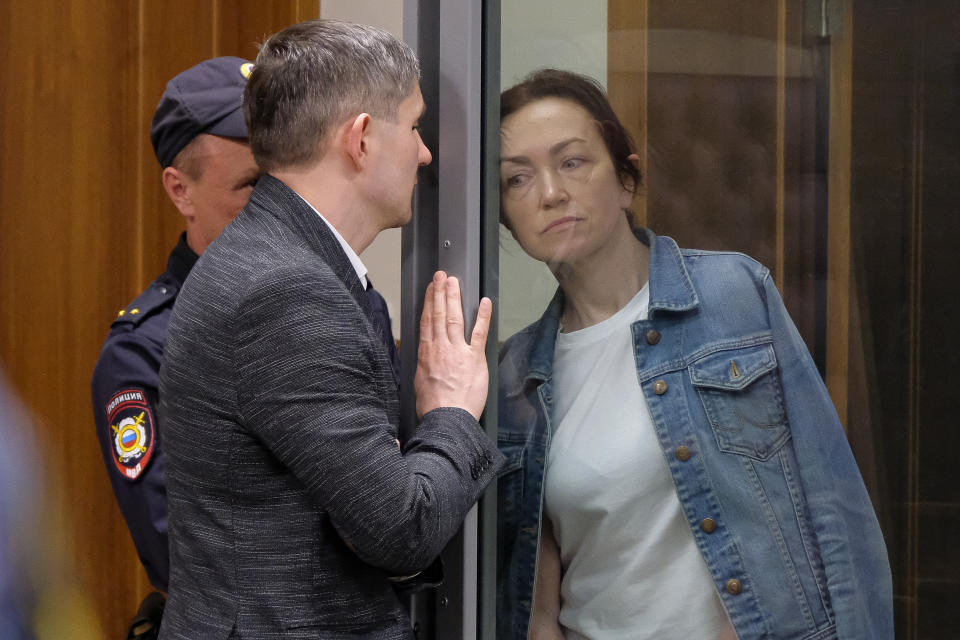 Alsu Kurmasheva, an editor for the U.S. government-funded Radio Free Europe/Radio Liberty's Tatar-Bashkir service, listens to her lawyer during a court hearing in Kazan, Russia on Friday, May 31, 2024. A court in Russia on Friday ordered the detained Russian American journalist to be held until at least Aug. 5, pending investigation and trial, a further step in the Kremlin's crackdown on dissent and free speech. (AP Photo)