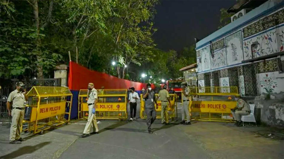 Police officers are pictured here stationed outside the Arun Jaitley Stadium in Delhi to enforce a night curfew.