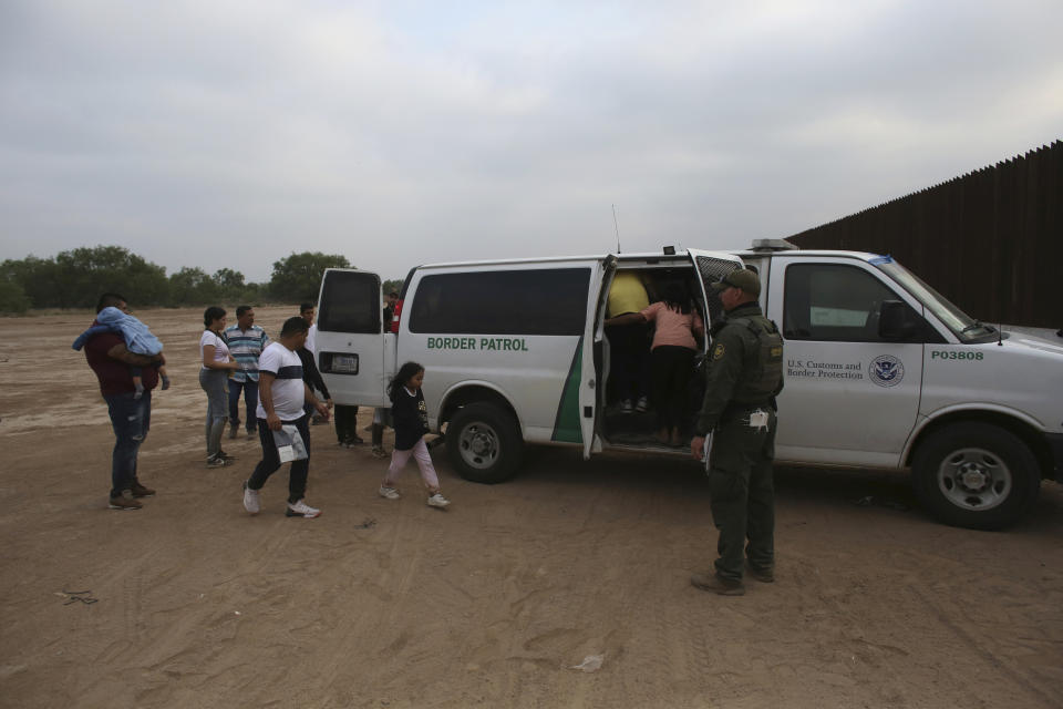 Migrants who had crossed the Rio Grande river into the U.S. are taken away by U.S. Border Patrol agents in Eagle Pass, Texas, Friday, May 20, 2022. The Eagle Pass area has become increasingly a popular crossing corridor for migrants, especially those from outside Mexico and Central America, under Title 42 authority, which expels migrants without a chance to seek asylum on grounds of preventing the spread of COVID-19. A judge was expected to rule on a bid by Louisiana and 23 other states to keep Title 42 in effect before the Biden administration was to end it Monday. (AP Photo/Dario Lopez-Mills)