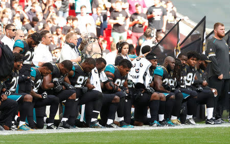 NFL Football - Jacksonville Jaguars vs Baltimore Ravens - NFL International Series - Wembley Stadium, London, Britain - September 24, 2017 Jacksonville Jaguars players kneel during the U.S. national anthem before the match Action Images via Reuters/Andrew Boyers