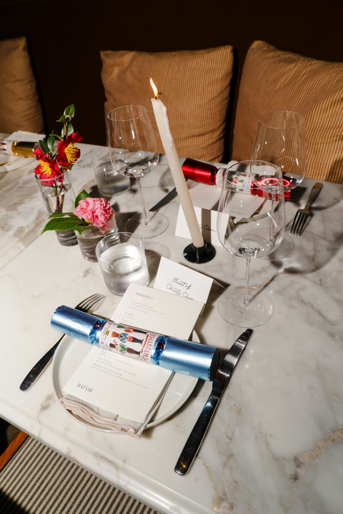 a table with a candle and glasses