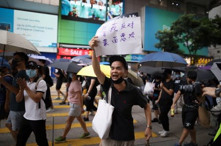 Anti-government demonstrators march in protest against the invocation of the emergency laws in Hong Kong