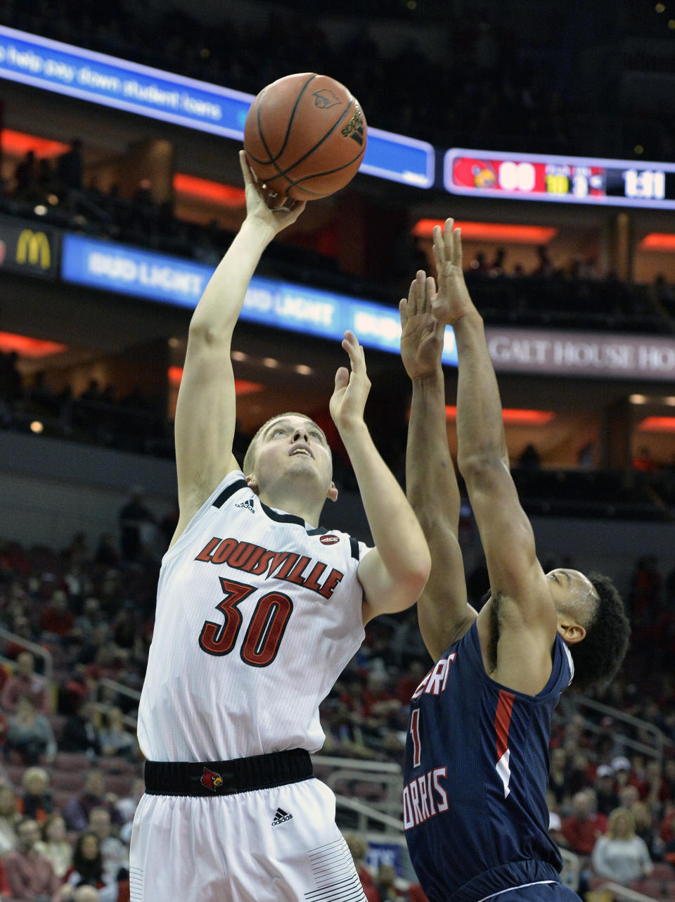 Louisville guard Ryan McMahon (30) shoots over the defense of Robert Morris guard Jon Williams (1) during the second half of an NCAA college basketball game in Louisville, Ky., Friday, Dec. 21, 2018. (AP Photo/Timothy D. Easley)