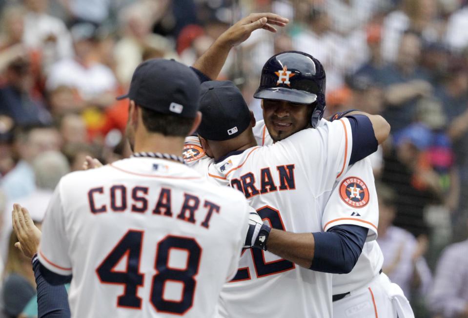 Houston Astros' Jesus Guzman, right, is congratulated by teammates after hitting a two-run home run in the first inning of a baseball game against the New York Yankees, Tuesday, April 1, 2014, in Houston. (AP Photo/Patric Schneider)