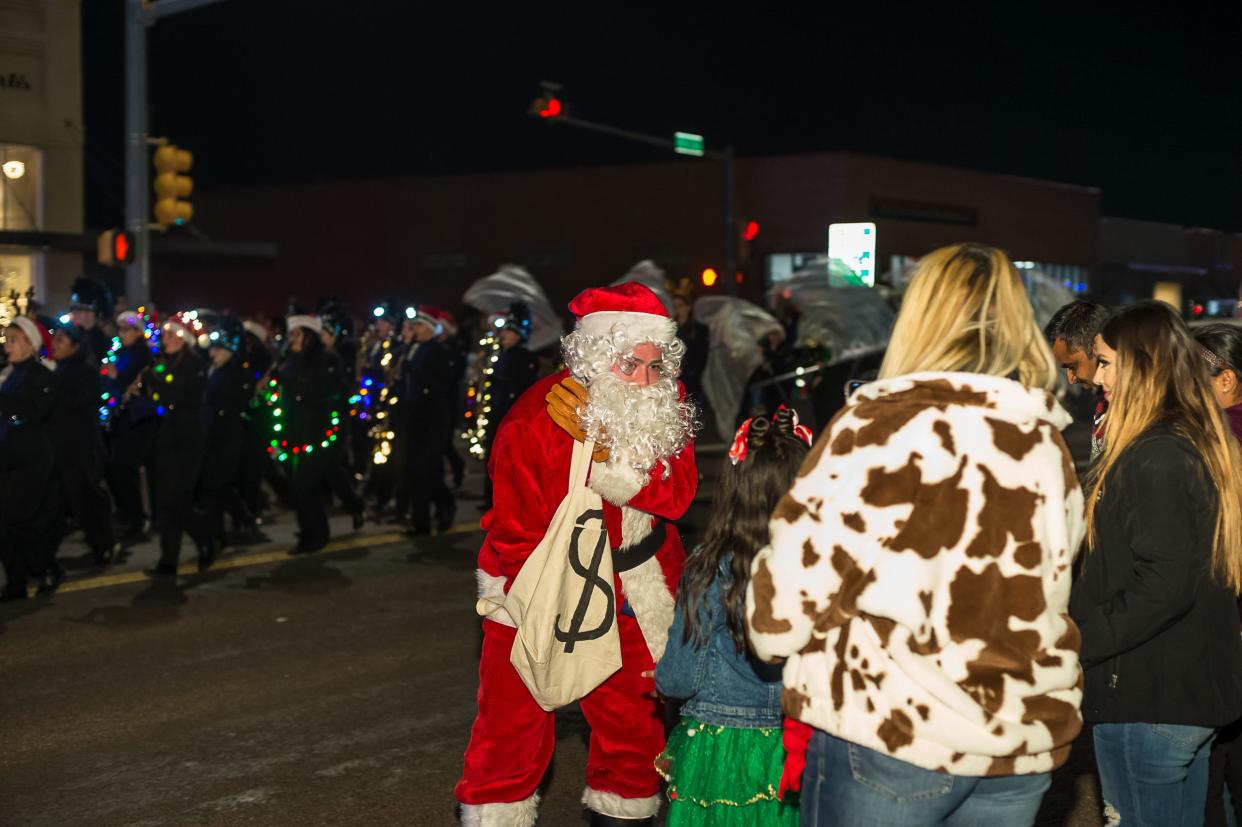 Santa Claus hands out candy during the city of Canyon's Parade of Lights on Saturday evening. Floats in the annual parade represent local youth organizations. For more photos from Saturday's event, see a photo gallery at amarillo.com