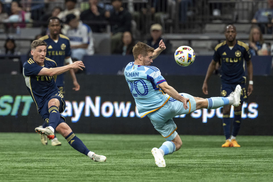 Vancouver Whitecaps' Ryan Gauld, left, kicks the ball past Colorado Rapids' Connor Ronan (20) during the second half of an MLS soccer match Saturday, June 1, 2024, in Vancouver, British Columbia. (Ethan Cairns/The Canadian Press via AP)