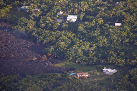 Lava threatens homes in the Kapoho area, east of Pahoa, during ongoing eruptions of the Kilauea Volcano in Hawaii, U.S., June 5, 2018. REUTERS/Terray Sylvester