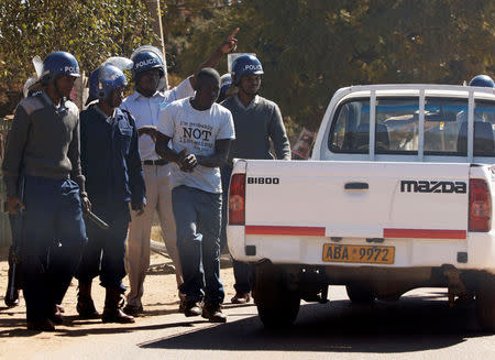 Anti-riot policemen detain a suspected rioter in Mufakose, Harare, Zimbabwe, July 6, 2016. REUTERS/Philimon Bulawayo