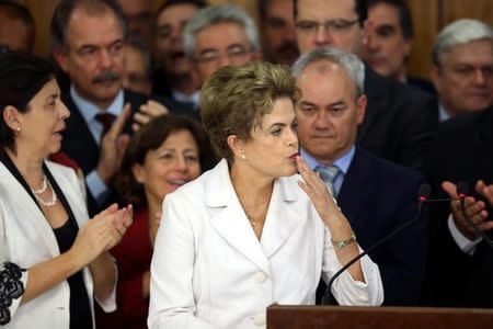 Suspended Brazilian President Dilma Rousseff gestures to supporters as she speaks after the Brazilian Senate vote to impeach her for breaking budget laws at Planalto Palace in Brasilia, Brazil, May 12, 2016. REUTERS/Adriano Machado