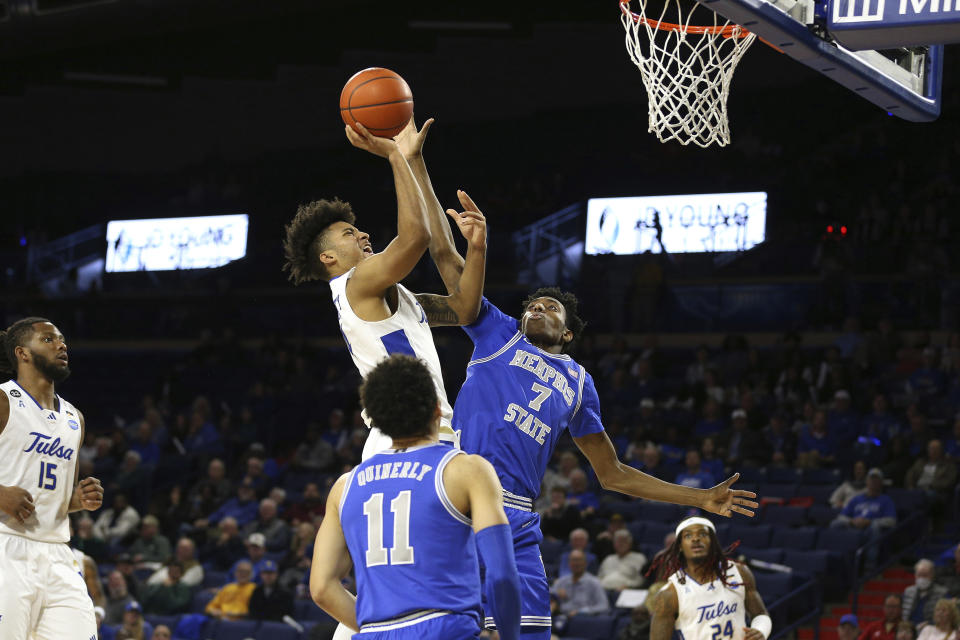 Tulsa guard PJ Haggerty (4) is fouled by Memphis forward Nae'Qwan Tomlin (7) during the second half of an NCAA college basketball game Thursday, Jan. 4, 2024, in Tulsa, Okla. (AP Photo/Joey Johnson)