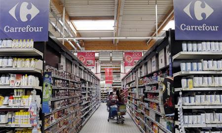 Customers shop in an aisle at the Carrefour hypermarket in Brive-La-Gaillarde, central France, July 8, 2013. REUTERS/Regis Duvignau