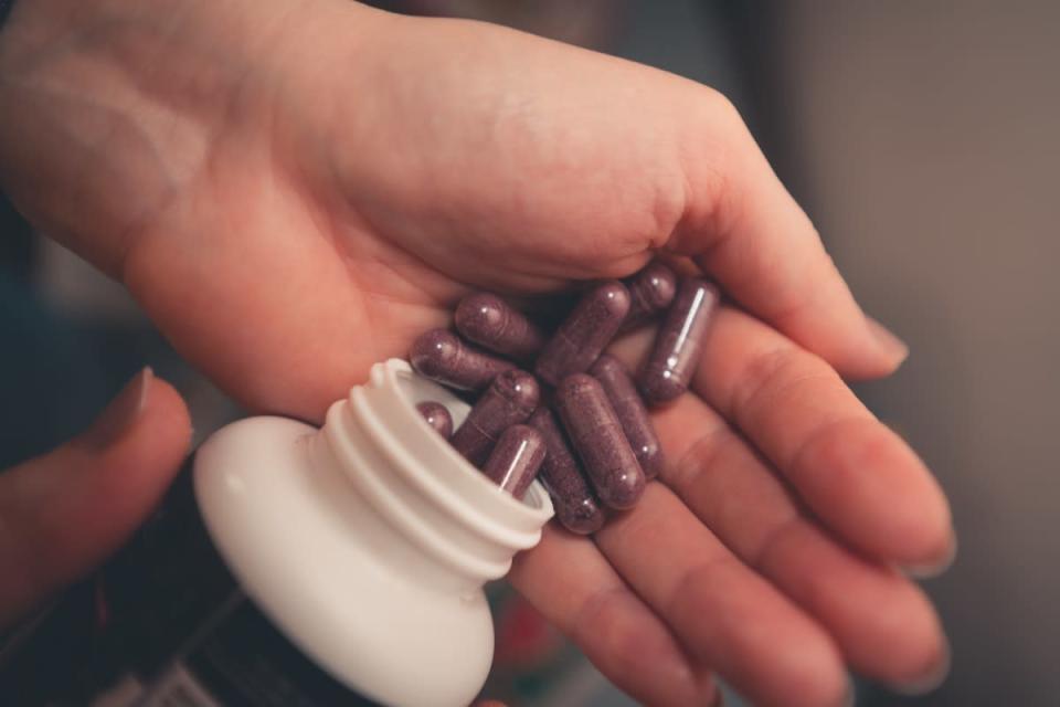 person holding pills in their hands