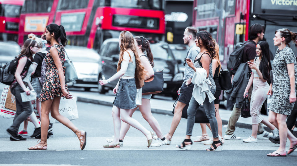 London, UK - 24 August, 2016: Lots of people walking in Oxford street, is the main destination of tourists and Londoners for shopping. People caring shopping bags. Modern life concept