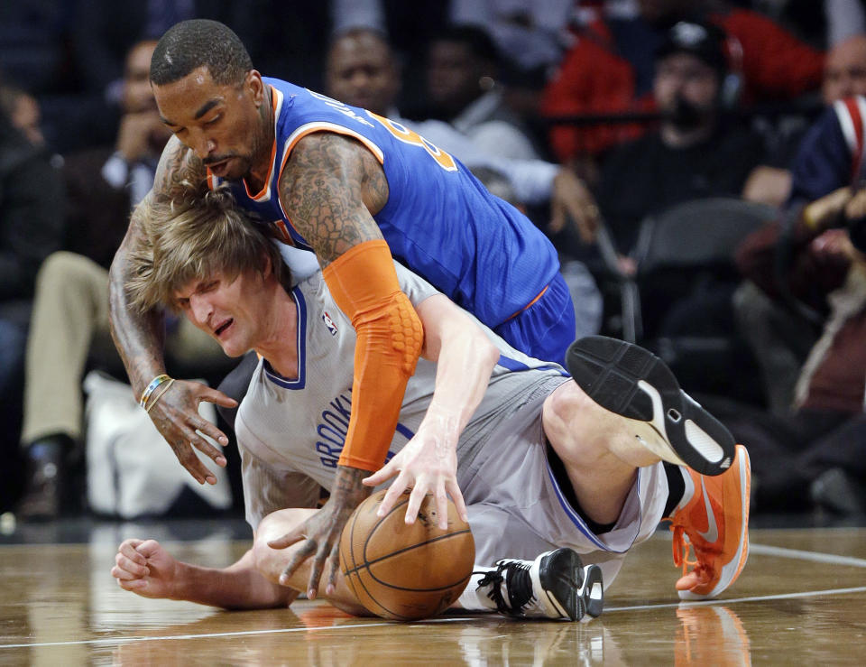 New York Knicks' J.R. Smith, above, and Brooklyn Nets' Andrei Kirilenko, of Russia, scramble for control of the ball during the first half of an NBA basketball game Tuesday, April 15, 2014, in New York. (AP Photo/Frank Franklin II)