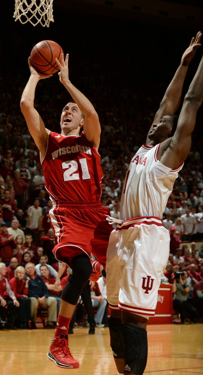 Chris Howell | Herald-Times Wisconsin Badgers guard Josh Gasser (21) shoots around Indiana forward Noah Vonleh (1) during the Indiana Wisconsin men's basketball game at Assembly Hall in Bloomington, Ind., Tuesday, Jan. 14, 2014.