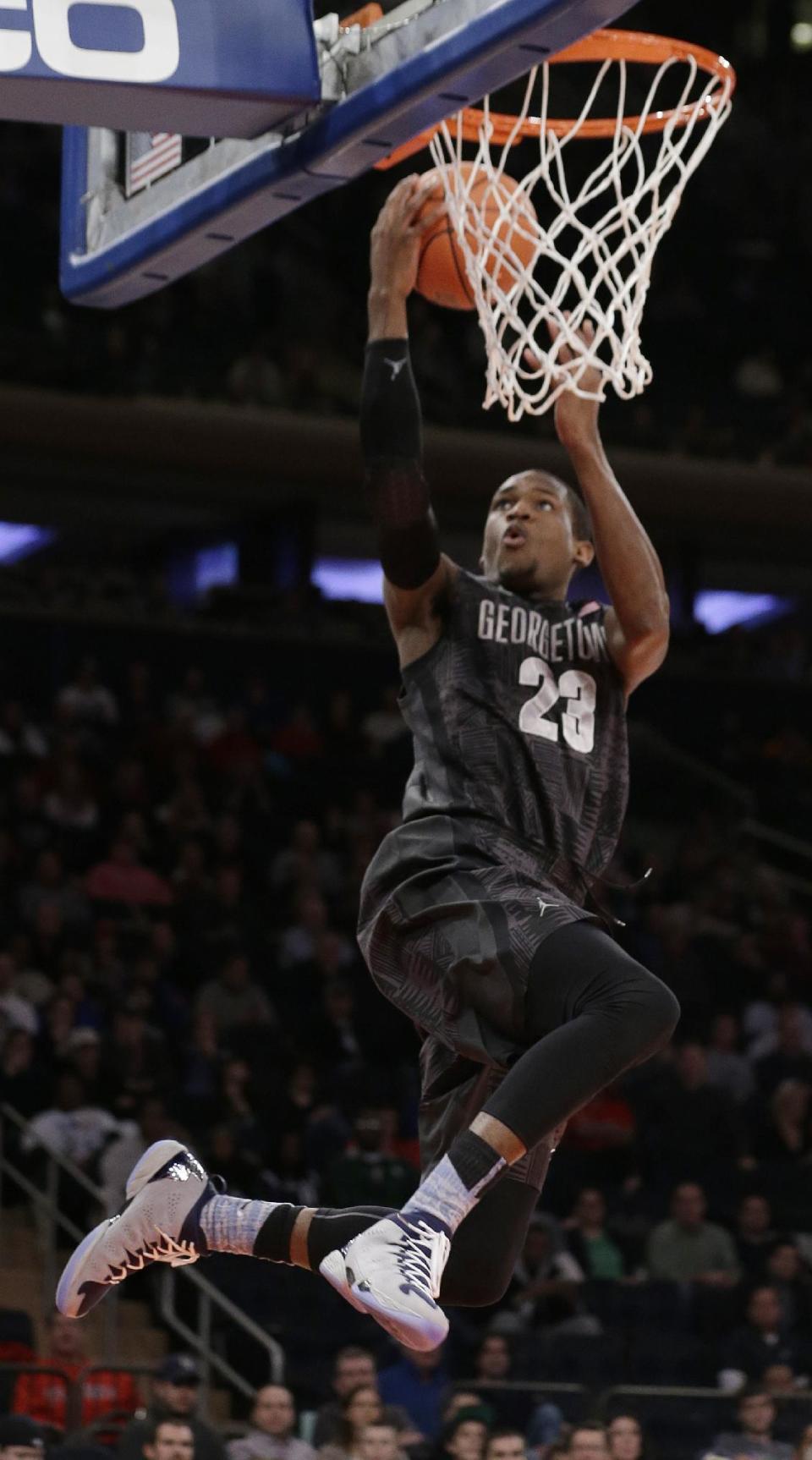 Georgetown's Aaron Bowen (23) scores during the first half of an NCAA basketball game against Michigan State Saturday, Feb. 1, 2014, in New York. (AP Photo/Frank Franklin II)