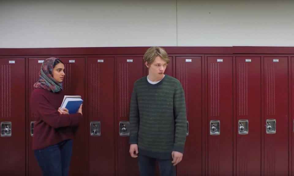 Geraldine Viswanathan and Jack Kilmer stand outside lockers