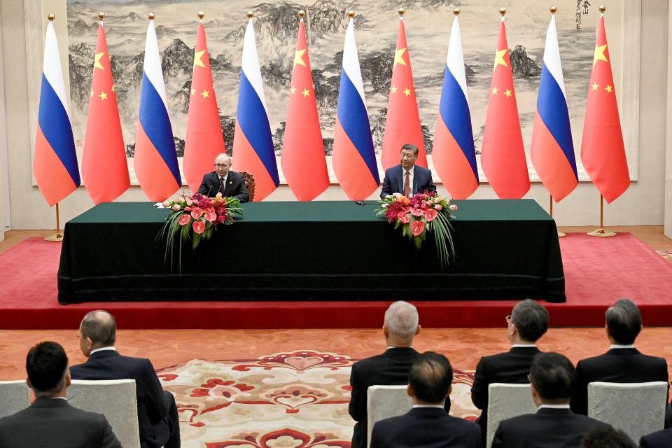 In this pool photograph distributed by the Russian state agency Sputnik, Russia's President Vladimir Putin and China's President Xi Jinping attend a signing ceremony following their talks in Beijing (POOL/AFP via Getty Images)