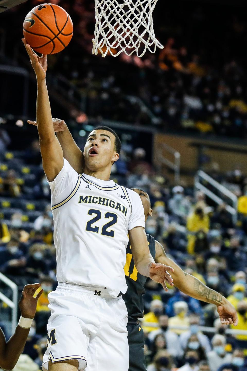 Michigan forward Caleb Houstan makes a layup against Iowa during the first half at the Crisler Center on Thursday, March 3, 2022.