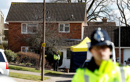 Police officers stand guard outside the home of Sergei Skripal in Salisbury, Britain, March 8, 2018. REUTERS/Peter Nicholls