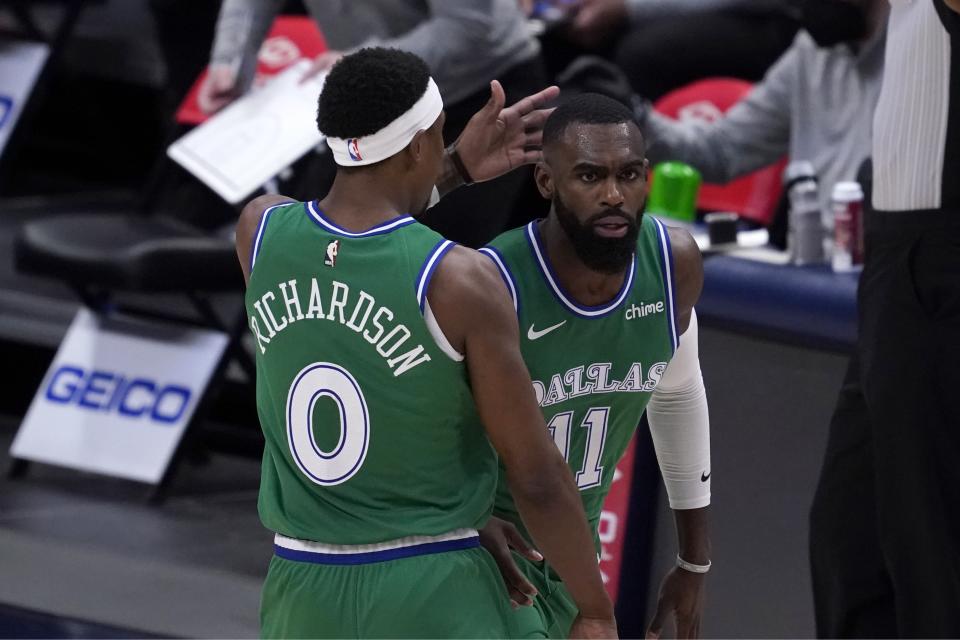 Dallas Mavericks' Josh Richardson (0) and Tim Hardaway Jr., right, celebrate a three-point basket scored by Hardaway in the first half of an NBA basketball game against the Memphis Grizzlies in Dallas, Monday, Feb. 22, 2021. (AP Photo/Tony Gutierrez)