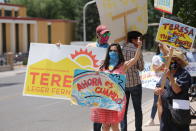 Democratic congressional candidate Teresa Leger Fernandez flashes a thumbs-up to drivers at a polling station Tuesday, June 2, 2020, in Santa Fe, N.M. Opponents in the crowded Democratic primary included former CIA operative Valerie Plame. The sign she holds, "Ahora es cuando," is Spanish for "Now is the time." (AP Photo/Cedar Attanasio)