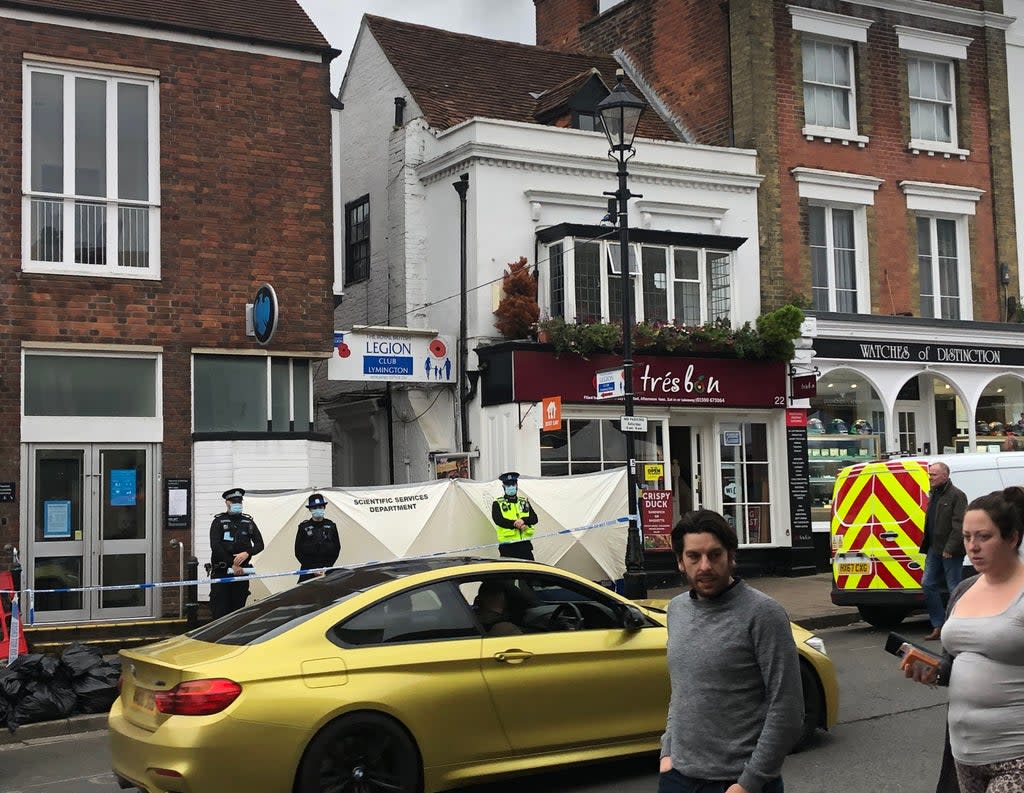 Police at the scene outside the Royal British Legion on High Street in Lymington, Hampshire, where two men and a woman were found with stab wounds on Friday (PA)