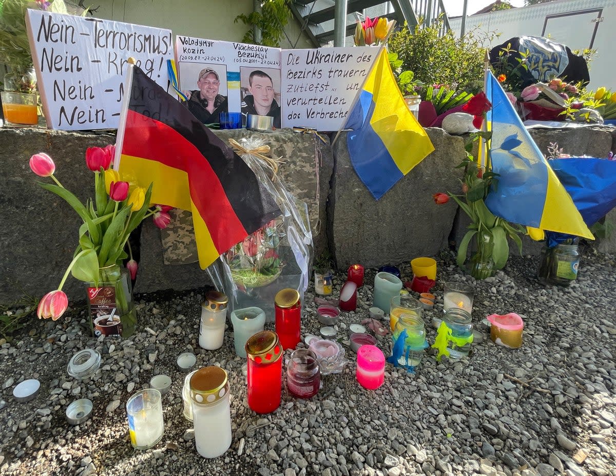 Flowers and candles are placed at the scene, as residents mourn the death of two Ukrainian soldiers (REUTERS)