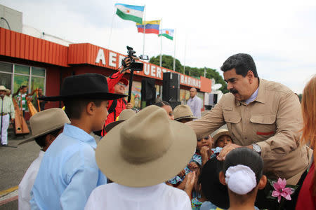 Venezuela's President Nicolas Maduro greets children upon his arrival at a campaign rally in Barinas, Venezuela April 23, 2018. Miraflores Palace/Handout via REUTERS