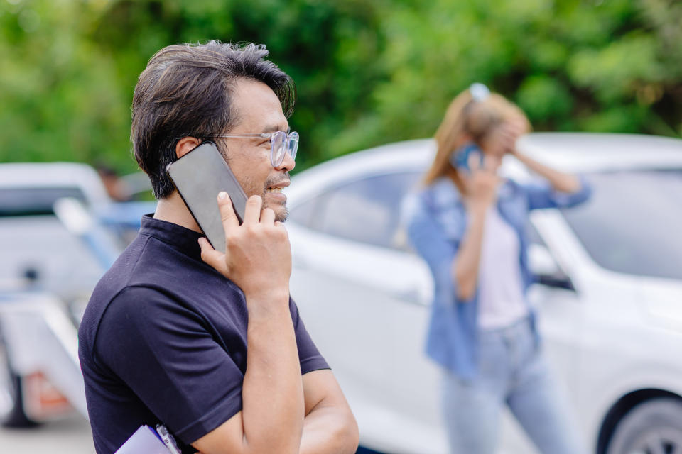 car crash accident man and women calling insurance agency for help