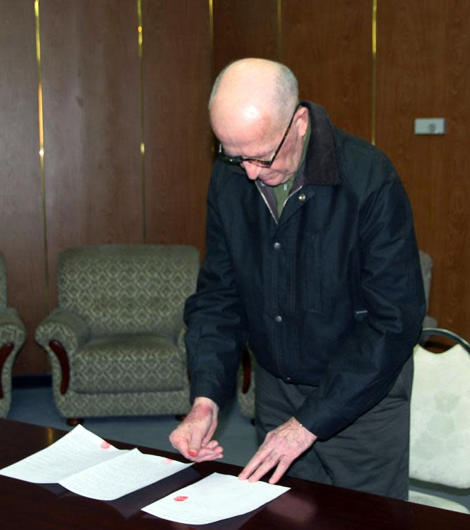 KCNA handout photo provided on March 3, 2014 shows Australian missionary John Short making an official apology at an undisclosed location in North Korea