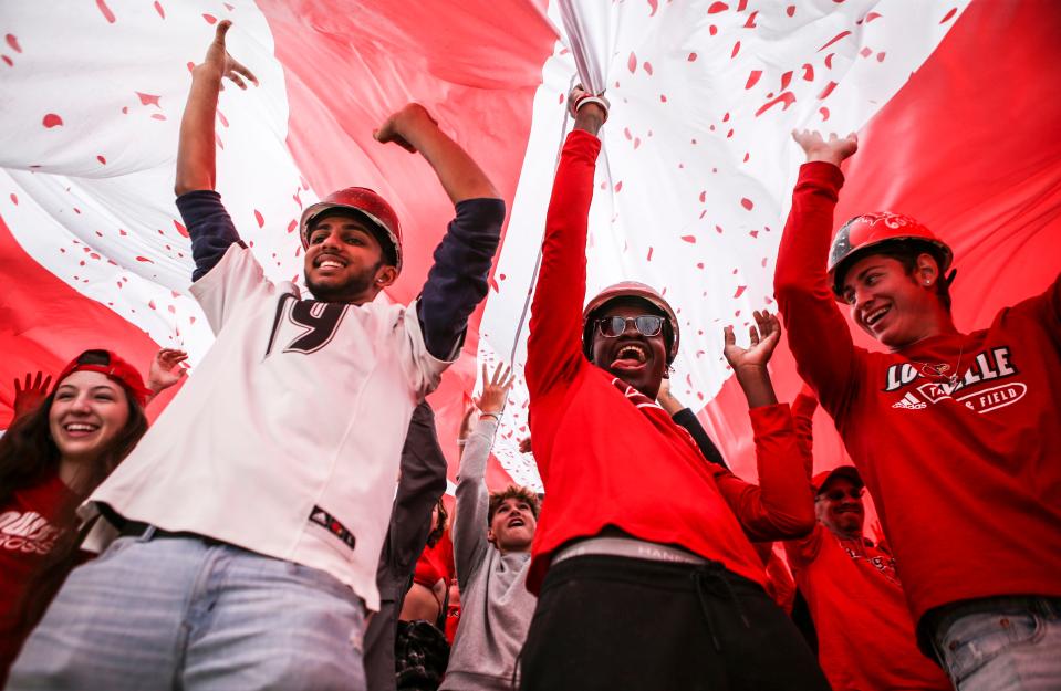 UofL students held up a Cardinal banner overhead at Cardinal Stadium Saturday. UofL beat Boston College and is now 4-3 and breaks a two-game losing streak. Oct. 23, 2021