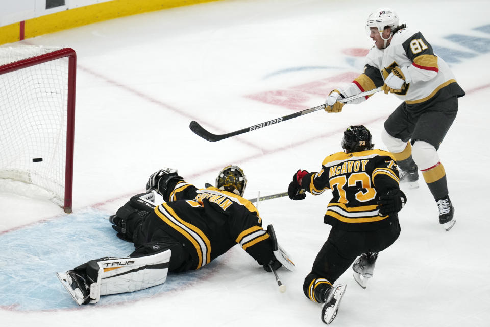 Vegas Golden Knights center Jonathan Marchessault (81) fires the puck past Boston Bruins goaltender Jeremy Swayman on his goal during the first period of an NHL hockey game, Monday, Dec. 5, 2022, in Boston. In foreground is Boston Bruins defenseman Charlie McAvoy (73). (AP Photo/Charles Krupa)