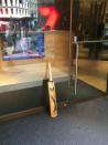 7Sport reporter Matt Carmichael places a bat outside the Channel Seven office in Sydney.