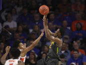 Baylor guard Devonte Bandoo (2) takes a shot over Florida guard Tre Mann (1) during the first half of an NCAA college basketball game Saturday, Jan. 25, 2020, in Gainesville, Fla. (AP Photo/Matt Stamey)